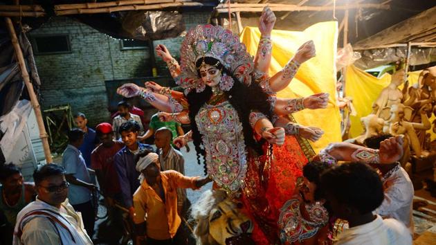 A finished clay idol of the Hindu Goddess Durga is transported to worship place from a workshop in Allahabad.(AFP)