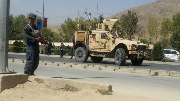 An Afghan policeman keeps watch at the site of a car bomb attack in Kabul on September 24.(Reuters Photo)