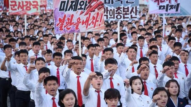 An anti-US rally at Kim Il Sung Square is seen in this September 23, 2017 photo released by North Korea's Korean Central News Agency (KCNA) in Pyongyang . Placards read (L-R) "A global military power", "Be through with the US", "The US is evil's headquarters", "Old foe the US".(KCNA/via REUTERS)