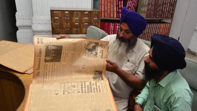 A researcher finding a piece of writing in a Hindustan Times edition from 1965 at Sikh Reference Library, Amritsar.(Sameer Sehgal/HT)