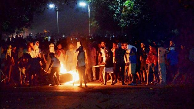 A bike in flames during clashes between the students and police at Banaras Hindu University in Varanasi.(PTI Photo) A bike in flames during clashes between the students and police at Banaras Hindu University in Varanasi.(PTI Photo)