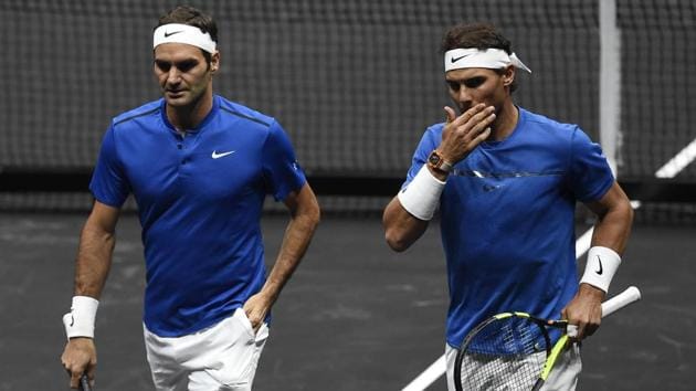 Roger Federer and Rafael Nadal of Team Europe talk during their match against Sam Querrey and Jack Sock at Laver Cup.(AFP)