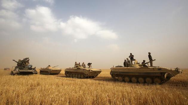 Iraqi forces advance towards the city of al-Sharqat on September 21, 2017, where Iraqi forces backed by Hashed al-Shaabi (Popular Mobilisation) paramilitaries are preparing to retake the jihadist-held city of Hawijah in the province of Kirkuk, 300 kilometres (185 miles) northwest of Baghdad. (AFP) Iraqi forces advance towards the city of al-Sharqat on September 21, 2017, where Iraqi forces backed by Hashed al-Shaabi (Popular Mobilisation) paramilitaries are preparing to retake the jihadist-held city of Hawijah in the province of Kirkuk, 300 kilometres (185 miles) northwest of Baghdad. (AFP)