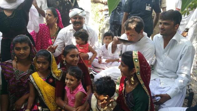 Rahul Gandhi sips tea with an Ahir family at Hanjrapar village on Monday during the first day of his Navsarjan Yatra. (HT Photo) Rahul Gandhi sips tea with an Ahir family at Hanjrapar village on Monday during the first day of his Navsarjan Yatra. (HT Photo)