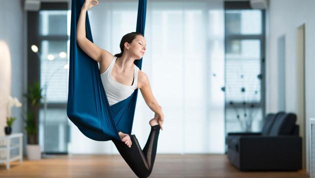 Anti-gravity yoga or aerial yoga combines the traditional yoga poses, Pilates and dance with the use of a hammock.(Shutterstock)