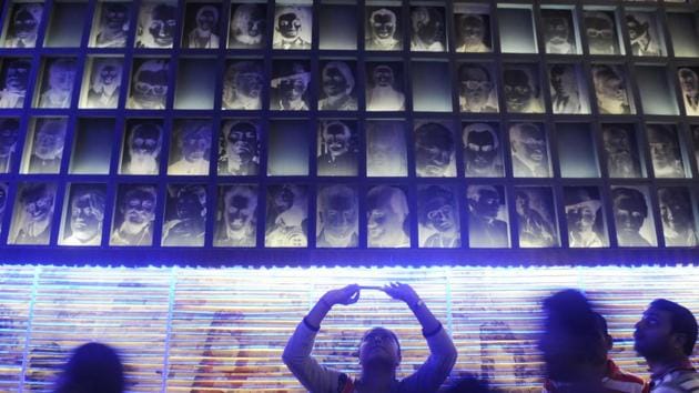 In Behala, the SB Park Durga Puja is a photographer’s delight where old negatives as well as prints are part of the theme. Prints of selfies are handed out as gifts to visitors.  (Samir Jana / HT Photo) 