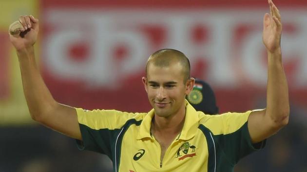 Ashton Agar celebrates after taking the wicket of Indian captain Virat Kohli during the third ODI at the Holkar Stadium in Indore on September 24, 2017.(AFP)