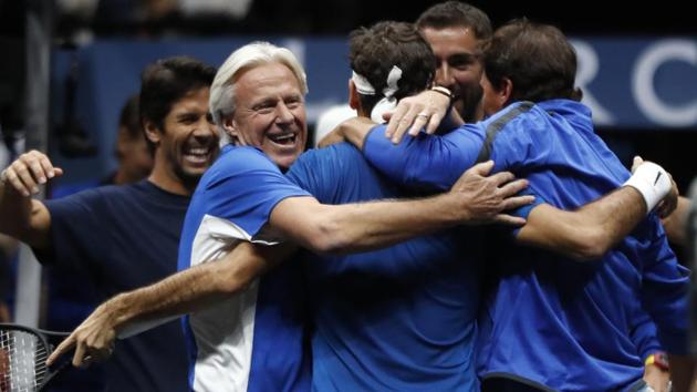 Roger Federer, center, celebrates with teammates and team's captain Bjorn Borg, left, after defeating World's Nick Kyrgios. (AP) Roger Federer, center, celebrates with teammates and team's captain Bjorn Borg, left, after defeating World's Nick Kyrgios. (AP)