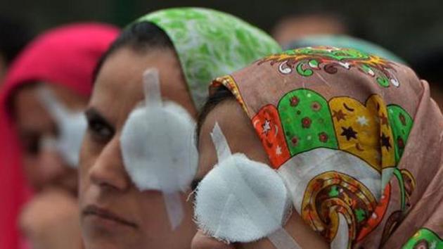 Kashmiri doctors and paramedics take part in a protest at a hospital in Srinagar, August 10, 2016. The protesters covered one of their eyes to show the plight of the victims of pellet guns. Data from Kashmir’s hospitals show over 6,000 people – including children as young as four and teenaged girls – had suffered pellet injuries, with over 1,100 hit in the eyes(AFP)