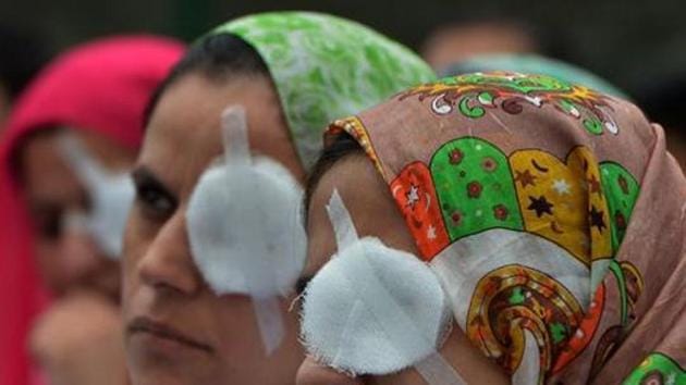 Kashmiri doctors and paramedics take part in a protest at a hospital in Srinagar, August 10, 2016. The protesters covered one of their eyes to show the plight of the victims of pellet guns. Data from Kashmir’s hospitals show over 6,000 people – including children as young as four and teenaged girls – had suffered pellet injuries, with over 1,100 hit in the eyes(AFP)