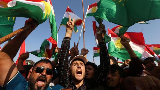 Iraqi Kurds fly Kurdish flags during an event to urge people to vote in the independence referendum in Erbil, the capital of the autonomous Kurdish region of northern Iraq, on September 22, 2017. Leading to the vote, Kurdish flags were festooned in the streets, on cars and outside homes across Iraqi Kurdistan. People in caps emblazoned with the Kurdish colours of red, white, green and yellow, and regional flags around their necks and shoulders were out on the streets calling for the vote. (Safin Hamed / AFP) Iraqi Kurds fly Kurdish flags during an event to urge people to vote in the independence referendum in Erbil, the capital of the autonomous Kurdish region of northern Iraq, on September 22, 2017. Leading to the vote, Kurdish flags were festooned in the streets, on cars and outside homes across Iraqi Kurdistan. People in caps emblazoned with the Kurdish colours of red, white, green and yellow, and regional flags around their necks and shoulders were out on the streets calling for the vote. (Safin Hamed / AFP)