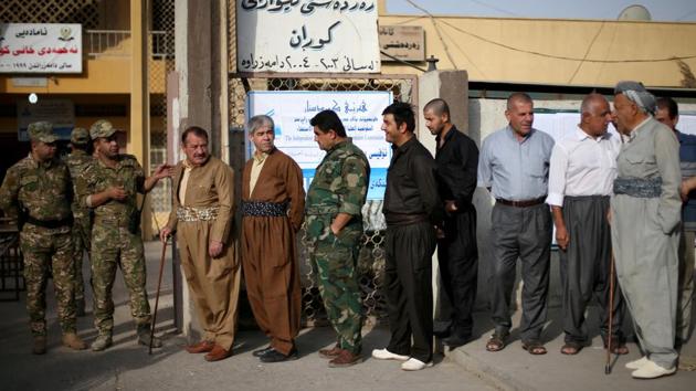 Security men and residents line up during the independence referendum in Erbil, Iraq on September 25, 2017.Voters headed to the polls with many men dressed in traditional Kurdish attire of brown shirt and billowing trousers. ‘I came very early to be the first to vote for a Kurdish state,’ Diyar Abubakr, 33, said outside a polling station. ‘It’s a day of celebration today. That’s why I’ve put on our traditional outfit, which I bought for the occasion,’ he said. (Ahmed Jadallah / RETUERS) Security men and residents line up during the independence referendum in Erbil, Iraq on September 25, 2017.Voters headed to the polls with many men dressed in traditional Kurdish attire of brown shirt and billowing trousers. ‘I came very early to be the first to vote for a Kurdish state,’ Diyar Abubakr, 33, said outside a polling station. ‘It’s a day of celebration today. That’s why I’ve put on our traditional outfit, which I bought for the occasion,’ he said. (Ahmed Jadallah / RETUERS)