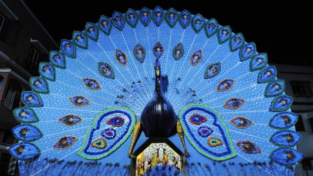 At the Monotosh Smritisangha Durga Puja in Rashbehari, South Kolkata, India’s national bird, the peacock, finds itself central to the pandal’s decorative aesthetic. (Samir Jana / HT Photo) 