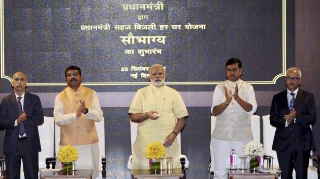 Prime Minister Narendra Modi launches the Sahaj Bijli Har Ghar Yojana or Saubhagya, to supply electricity to poor households, in New Delhi on Monday. Petroleum Minister Dharmendra Pradhan and Power Minister RK Singh are also seen.(PTI)