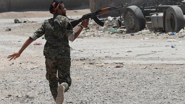 A Kurdish YPG fighter fires at ISIS militants in Raqqa, Syria on July 03, 2017. ‘We expect reactions from one side or another but we are convinced that whatever the risk and the price, it’s better than waiting for a dark outcome,’ Barzani said. ‘The referendum is not for defining borders or imposing a fait accompli. We want a dialogue with Baghdad to resolve the problems, and the dialogue can last one or two years,’ he said of zones such as Kirkuk. (Goran Tomasevic / REUTERS) A Kurdish YPG fighter fires at ISIS militants in Raqqa, Syria on July 03, 2017. ‘We expect reactions from one side or another but we are convinced that whatever the risk and the price, it’s better than waiting for a dark outcome,’ Barzani said. ‘The referendum is not for defining borders or imposing a fait accompli. We want a dialogue with Baghdad to resolve the problems, and the dialogue can last one or two years,’ he said of zones such as Kirkuk. (Goran Tomasevic / REUTERS)