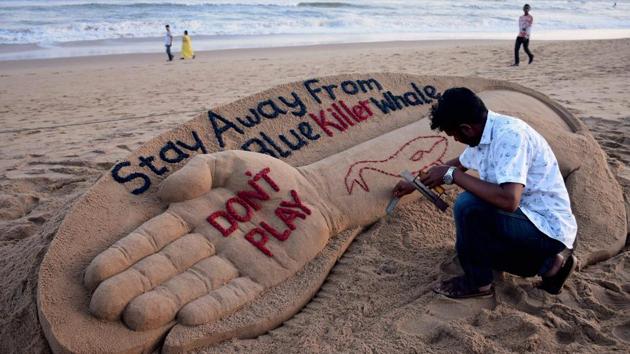 Sand artist Sudarsan Pattnaik creates a sand sculpture with message “Stay away from Blue Killer Whale : Don’t Play” at Puri beach in Odisha on Monday. (PTI) Sand artist Sudarsan Pattnaik creates a sand sculpture with message “Stay away from Blue Killer Whale : Don’t Play” at Puri beach in Odisha on Monday. (PTI)