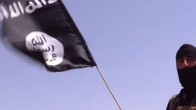 File photo of a member of the Islamic State waving the group’s black flag.(Reuters)