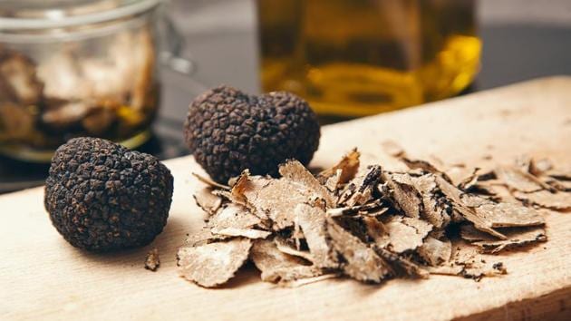 Black truffles on a wood board.(Shutterstock)