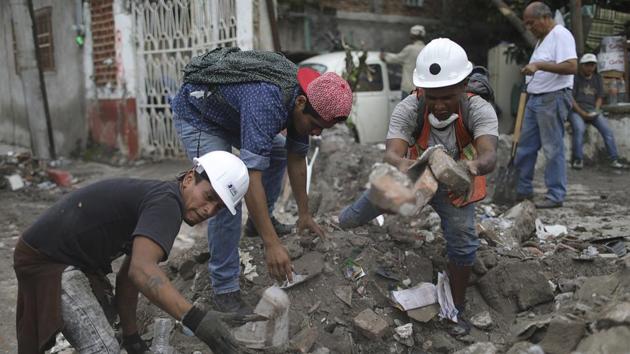 Hector Rodarte (2nd R), helps salvage personal items from a neighbor’s home, destroyed in a 7.1 magnitude earthquake, in Jojutla, Mexico. Rodarte says helping others ‘is something that is born from the bottom of my heart.’ Jojutla, about 60 miles (100 kilometers) south of the Mexican capital, is one of the places hit hardest by the September 19 quake, which killed at least 326 people. (Miguel Tovar / AP) Hector Rodarte (2nd R), helps salvage personal items from a neighbor’s home, destroyed in a 7.1 magnitude earthquake, in Jojutla, Mexico. Rodarte says helping others ‘is something that is born from the bottom of my heart.’ Jojutla, about 60 miles (100 kilometers) south of the Mexican capital, is one of the places hit hardest by the September 19 quake, which killed at least 326 people. (Miguel Tovar / AP)