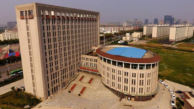 This photo taken on September 21, 2017 shows an aerial view of the building of the Career and Entrepreneurship Comprehensive Service Base of University Graduates at Zhengzhou in China's central Henan province. China has another entry when it comes to buildings that look suspiciously like something else - a 12-storey block at a university strongly resembling a giant toilet.(AFP)