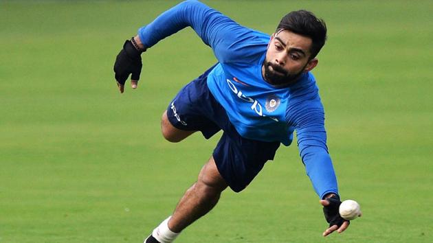 Virat Kohli dives to take a catch during a practice session ahead of the India vs Australia Bangalore ODI. (AFP) Virat Kohli dives to take a catch during a practice session ahead of the India vs Australia Bangalore ODI. (AFP)