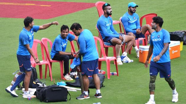 Indian cricketers take a break from the practice session held ahead of the fourth ODI at the M. Chinnaswamy Stadium in Bangalore.  (AFP) 