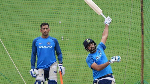 Rohit Sharma bats in the nets while his teammate M S Dhoni looks on during a net practice session held ahead of the fourth ODI at the M. Chinnaswamy Stadium in Bangalore.  (AFP) 