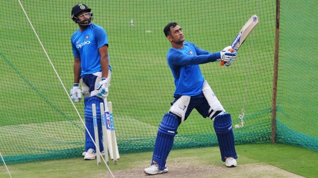 MS Dhoni bats in the nets while his teammate Rohit Sharma looks on during a net practice session ahead of the fourth ODI at the M. Chinnaswamy Stadium in Bangalore.  (AFP) 
