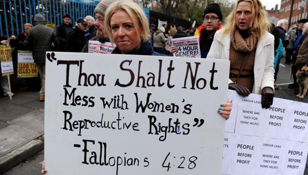 This photo taken on November 24, 2012 shows a protestor display a banner against Ireland's abortion laws during a march against Government austerity measures in Dublin, Ireland.(AFP File Photo)