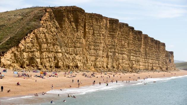 In Dorset, England, the East Cliff is a popular beach destination on the West Bay. West Bay beach was used in the introduction to the BBC television series ‘The Fall and Rise of Reginald Perrin’ and for location filming in the television series ‘Harbour Lights.’ (Matt Cardy / Getty Images) In Dorset, England, the East Cliff is a popular beach destination on the West Bay. West Bay beach was used in the introduction to the BBC television series ‘The Fall and Rise of Reginald Perrin’ and for location filming in the television series ‘Harbour Lights.’ (Matt Cardy / Getty Images)