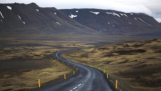 A long road runs through the scenic landscape of Egilsstaoir, Iceland. Iceland’s tourism industry continues to thrive; just eight years ago Iceland welcomed approximately 464,000 tourists and by last year nearly 1.7 million people visited the country. (Joe Raedle / Getty Images) A long road runs through the scenic landscape of Egilsstaoir, Iceland. Iceland’s tourism industry continues to thrive; just eight years ago Iceland welcomed approximately 464,000 tourists and by last year nearly 1.7 million people visited the country. (Joe Raedle / Getty Images)