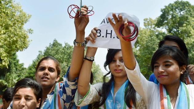 NSUI members demonstrating with bangles against the police action on Banaras Hindu University (BHU) girls, in New Delhi on Monday. (PTI Photo) NSUI members demonstrating with bangles against the police action on Banaras Hindu University (BHU) girls, in New Delhi on Monday. (PTI Photo)