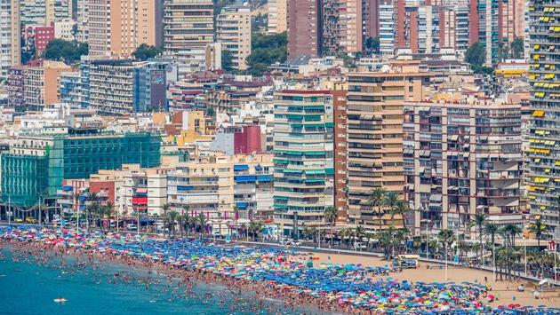 People sunbathe on Levante beach in Benidorm, Spain. A tiny fishing village till the 1960s, it’s now a popular Mediterranean holiday destination known for its nightlife. (David Ramos / Getty Images) People sunbathe on Levante beach in Benidorm, Spain. A tiny fishing village till the 1960s, it’s now a popular Mediterranean holiday destination known for its nightlife. (David Ramos / Getty Images)