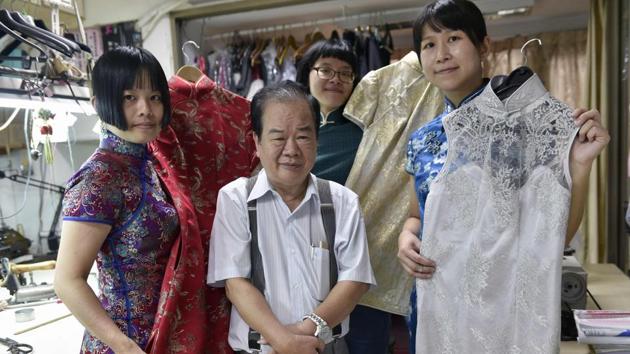 Taiwanese ‘qipao’ maker Lin Chin-te (C) and his students posing for photos at his studio in Taipei. Lin Chin-te, 74, is among a handful of craftsmen in Taiwan who still specialise in handmaking the high-collar, figure-hugging garment which was once part of many women's daily wardrobes.(AFP)