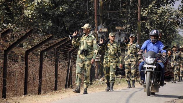 A motorcyclist riding past Border Security Force (BSF) personnel taking part in a routine patrol near the India-Bangladesh border in the village of Lankamura, on the outskirts of Agartala on February 9.(AFP Photo) A motorcyclist riding past Border Security Force (BSF) personnel taking part in a routine patrol near the India-Bangladesh border in the village of Lankamura, on the outskirts of Agartala on February 9.(AFP Photo)