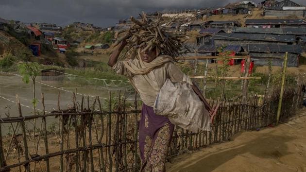 A Rohingya Muslim woman, who crossed over from Myanmar into Bangladesh, walks back to her shelters as she carries firewood on her head in Taiy Khali refugee camp, Bangladesh, on September 27. (AP File Photo) A Rohingya Muslim woman, who crossed over from Myanmar into Bangladesh, walks back to her shelters as she carries firewood on her head in Taiy Khali refugee camp, Bangladesh, on September 27. (AP File Photo)