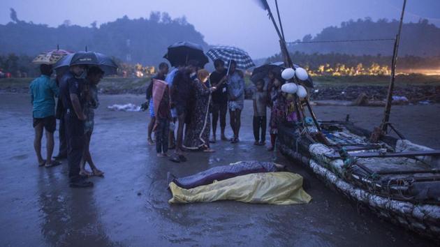 People gather around bodies of Rohingya Muslim refugees, on the shore of Inani beach, near Cox's Bazar on September 28.(AFP Photo)