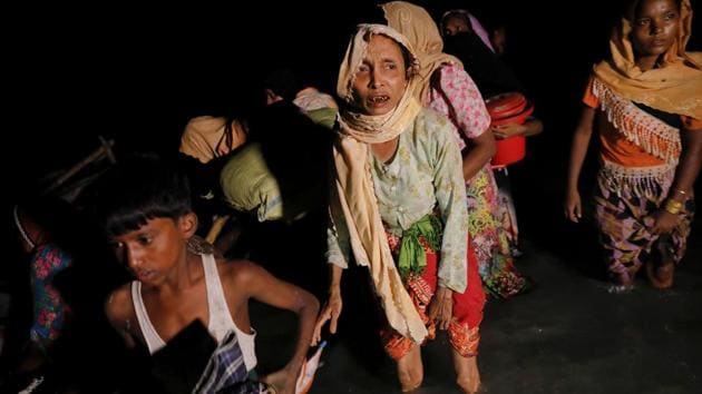 Women and children make their way to the shore as hundreds of Rohingya refugees arrive under the cover of darkness by wooden boats from Myanmar to Shah Porir Dwip, in Teknaf, near Cox's Bazar in Bangladesh, September 27.(REUTERS)