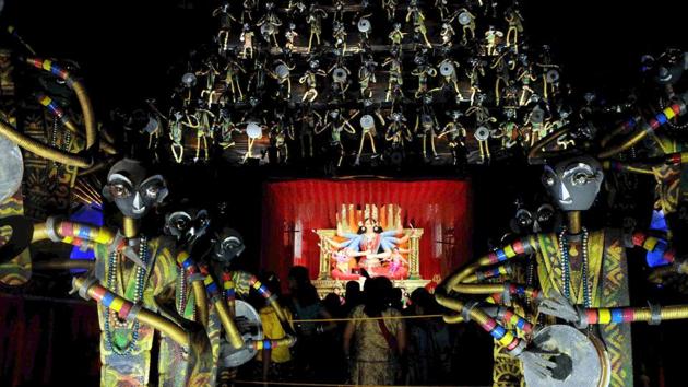 In Ranchi, the Durga Puja pandal of the OCC Durga Puja Club has incorporated tribal art forms of that region in its murals leading up to the main pandal. (Parwaz Khan/ HT Photo)