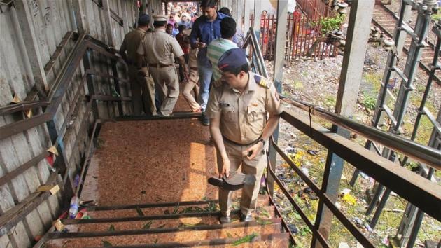Police look on at the site of a stampede that broke out on the Elphinstone Road (Prabhadevi) station bridge in Mumbai on Friday. Indian cricketers expressed their sorrow over the deaths.(PTI)