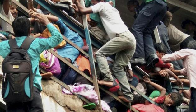 Mumbai: Passengers caught in a stampede at Elphinstone railway station's foot over bridge in Mumbai on Friday. (PTI) Mumbai: Passengers caught in a stampede at Elphinstone railway station's foot over bridge in Mumbai on Friday. (PTI)