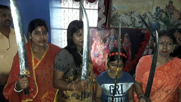 Women with swords at a shastra puja in Birbhum district. (HT PHOTO) Women with swords at a shastra puja in Birbhum district. (HT PHOTO)