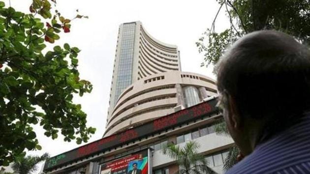 A man looks at a screen across a road displaying the Sensex on the facade of the Bombay Stock Exchange (BSE) building in Mumbai. (Reuters) A man looks at a screen across a road displaying the Sensex on the facade of the Bombay Stock Exchange (BSE) building in Mumbai. (Reuters)