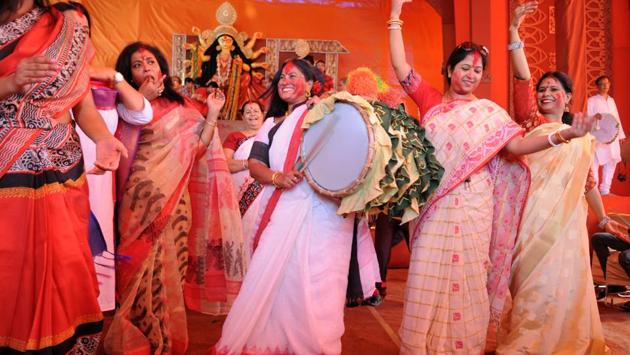 The five-day Durga Puja festivities came to an end today with the immersion of Durga idols. The women took part in the ‘Sindoor Khela’ ritual, smearing vermilion on each other at the puja organized by Purbapalli Durgabari Samiti in sector 15 part-2 community centre, in Gurgaon. They offered sweets and prayers to the goddess while the young swayed merrily to the rhythmic beats of the dhak (drums). (Parveen Kumar / HT Photo) The five-day Durga Puja festivities came to an end today with the immersion of Durga idols. The women took part in the ‘Sindoor Khela’ ritual, smearing vermilion on each other at the puja organized by Purbapalli Durgabari Samiti in sector 15 part-2 community centre, in Gurgaon. They offered sweets and prayers to the goddess while the young swayed merrily to the rhythmic beats of the dhak (drums). (Parveen Kumar / HT Photo)