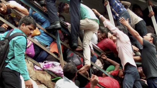 Passengers caught in a stampede at Elphinstone railway station's foot over bridge in Mumbai on Friday.(PTI Photo)