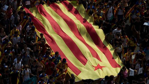 University students hold the Catalan pro-independence 'Estelada' flag during a demonstration against the position of the Spanish government on the referendum on self-determination during a students strike on September 28, 2017 in Barcelona. (Josep Lago / AFP) University students hold the Catalan pro-independence 'Estelada' flag during a demonstration against the position of the Spanish government on the referendum on self-determination during a students strike on September 28, 2017 in Barcelona. (Josep Lago / AFP)