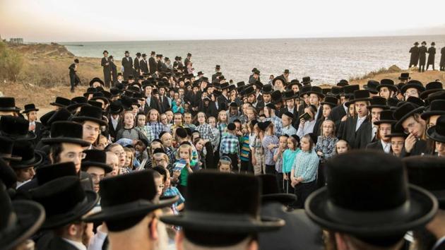 Orthodox Jewish men pray along the Mediterranean Sea in the Israeli city of Herzliya, near Tel Aviv, while performing the ‘Tashlich’ ritual on September 28, 2017, during which ‘sins are cast into the water to the fish’. The ‘Tashlich’ ritual is performed before the Day of Atonement, or Yom Kippur, the most important day in the Jewish calendar, which in 2017 began at sunset on September 29. (Jack Guez / AFP) Orthodox Jewish men pray along the Mediterranean Sea in the Israeli city of Herzliya, near Tel Aviv, while performing the ‘Tashlich’ ritual on September 28, 2017, during which ‘sins are cast into the water to the fish’. The ‘Tashlich’ ritual is performed before the Day of Atonement, or Yom Kippur, the most important day in the Jewish calendar, which in 2017 began at sunset on September 29. (Jack Guez / AFP)