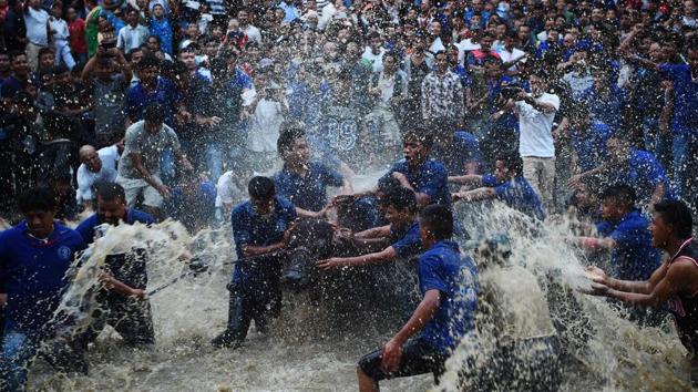 Nepali Hindu devotees splash water on a buffalo set to be sacrificed during the Hindu Dashain Festival in Bhaktapur, on the outskirts of Kathmandu, on September 29, 2017. Dashain is the longest and the most auspicious festival in the Nepalese calendar and celebrates the triumph of good over evil. (Prakash Mathema / AFP) Nepali Hindu devotees splash water on a buffalo set to be sacrificed during the Hindu Dashain Festival in Bhaktapur, on the outskirts of Kathmandu, on September 29, 2017. Dashain is the longest and the most auspicious festival in the Nepalese calendar and celebrates the triumph of good over evil. (Prakash Mathema / AFP)