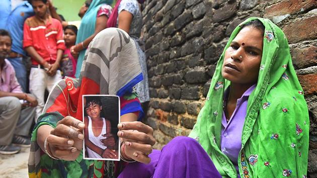 Ramratti holds up a photograph of her 6-year-old son Umesh, who was abducted and killed by a neighbour who initially planned to seek a ransom of Rs 20,000. (Raj K Raj/HT) Ramratti holds up a photograph of her 6-year-old son Umesh, who was abducted and killed by a neighbour who initially planned to seek a ransom of Rs 20,000. (Raj K Raj/HT)