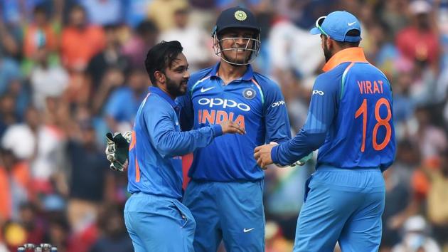 Indian wicket keeper Mahendra Singh Dhoni (C) celebrates with Kedar Jadhav (L) and captain Virat Kohli after the wicket of Australian captain Steven Smith during the fifth One-Day International at the Vidarbha Cricket Association Stadium in Nagpur on Sunday.(AFP)